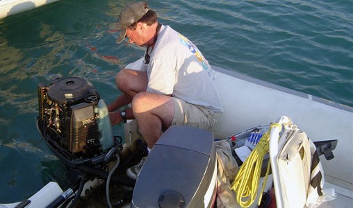 Once the Olympics begins, a coach's primary job is to eliminate distractions. At Athens 2004, that included coach boat outboard repair by Gary Bodie.